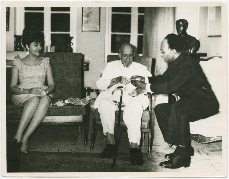 Kwame Nkrumah (right) and his wife, Fathia (left), presenting a gold watch to W.E.B. DuBois (seated and in center)) on the occasion of his 95th birthday