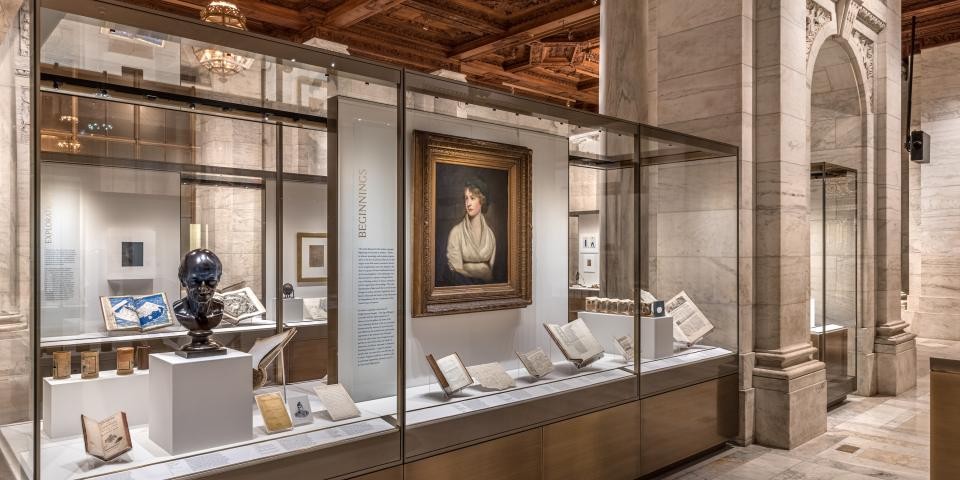 Interior of the Polonsky Exhibition of the New York Public Library's Treasures, including a large marble arch. 