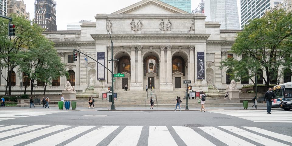 Exterior of the Stephen A. Schwarzman Building. A marble building with wide steps and a Lion on either side of the steps.