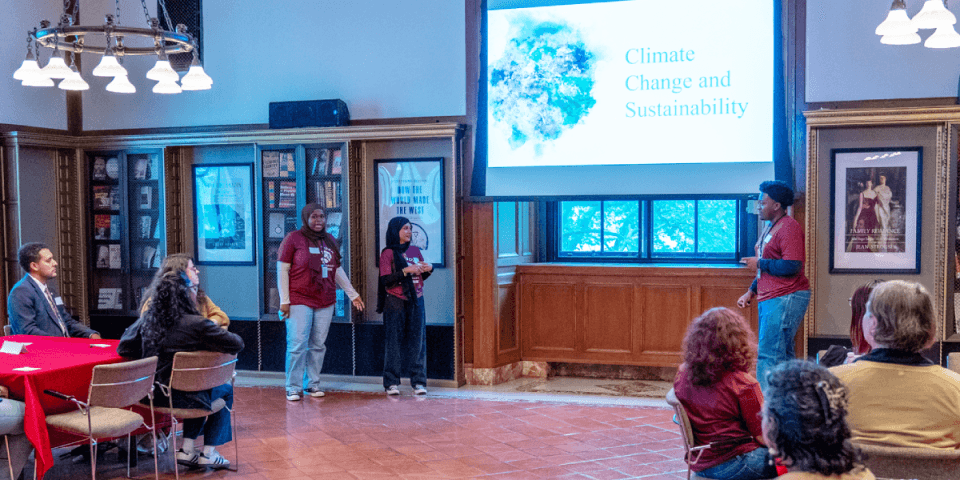 Three teens leading a presentation on climate change and sustainability