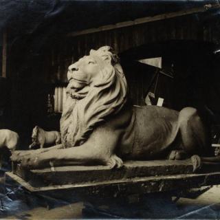 Historic photo of marble lion in sculptor’s studio.