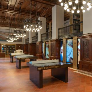 Interior of the Stephen A. Schwarzman Building Visitor Center, featuring chandeliers and several tactile, interactive tables.