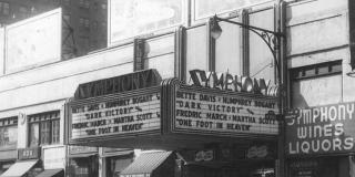 In a 1950s black and white photograph shows a theatre marquee for the Symphony Theatre