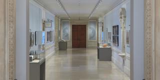 Photograph of exhibition showing entryway and both sides of the Rayner Wing corridor
