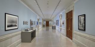 Photograph with fisheye view of exhibition showing both sides of the Rayner Wing corridor