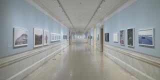 Photograph with fisheye view of exhibition showing both sides of the Print Gallery corridor