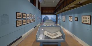 Photograph with fisheye view of exhibition showing both sides of the Bartos gallery corridor