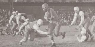 1937, Joe Lillard (center) eludes tackle while playing for the Brown Bombers football team