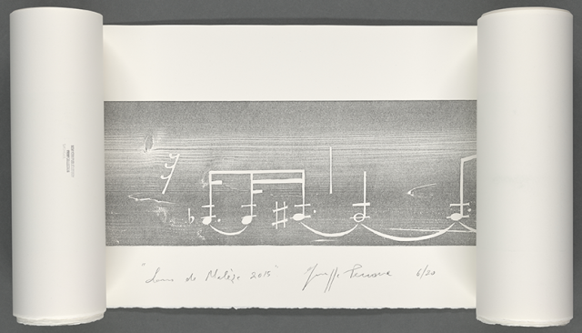 Partially unrolled scroll revealing a horizontal, black-and-white print of largescale musical notation; below it the artist has written the title, date, edition number, and his signature in pencil