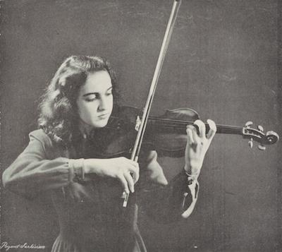 Anahid Ajemian is shown in a black and white photograph playing the violin.  