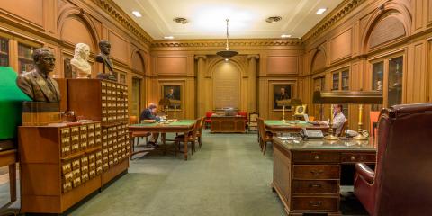 Interior of the Henry W. and Albert A. Berg Collection of English and American Literature, featuring several wooden desks and card catalog cupboards.